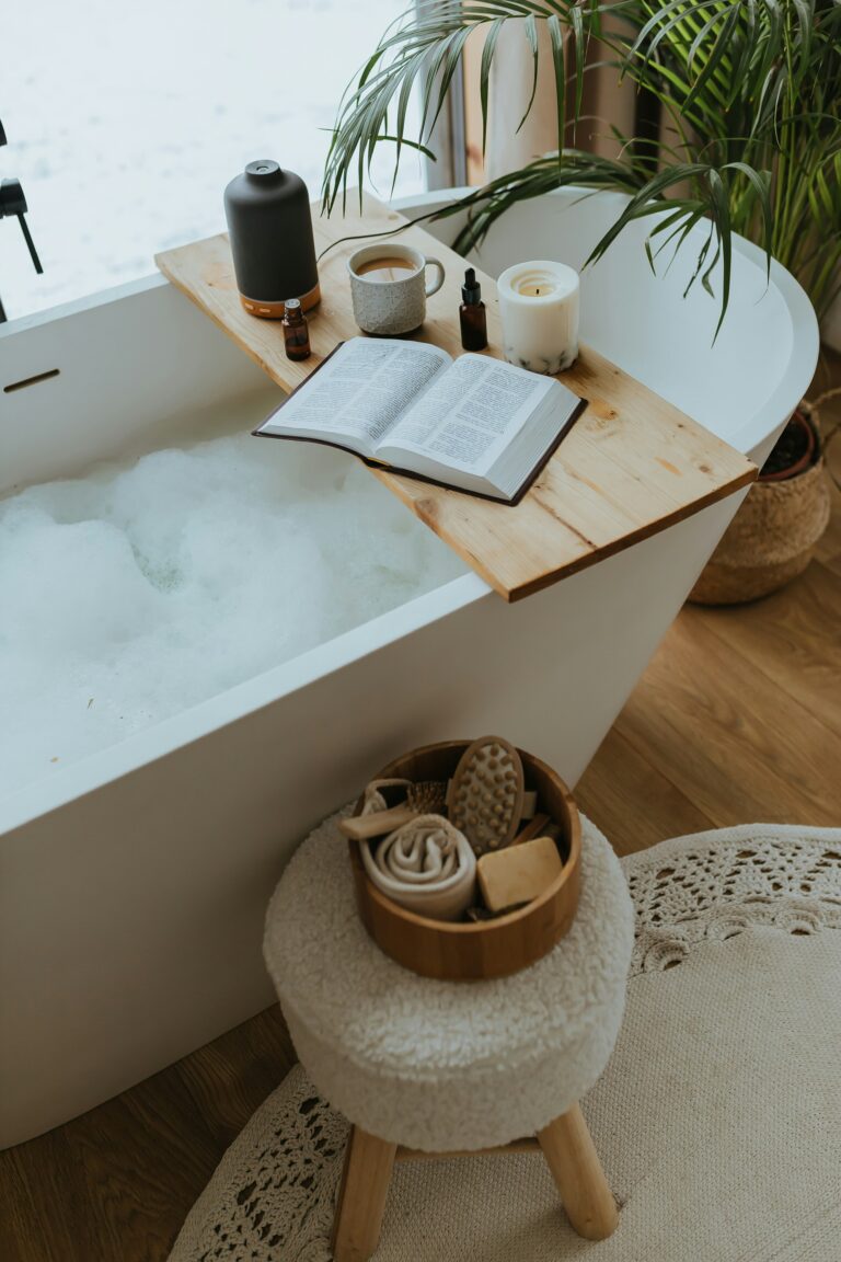 A Serene Bathtub Scene With a Wooden Tray Holding a Book, a Candle, and a Mug, Alongside a Cozy Stool With Bath Essentials. Ideal for Relaxation.